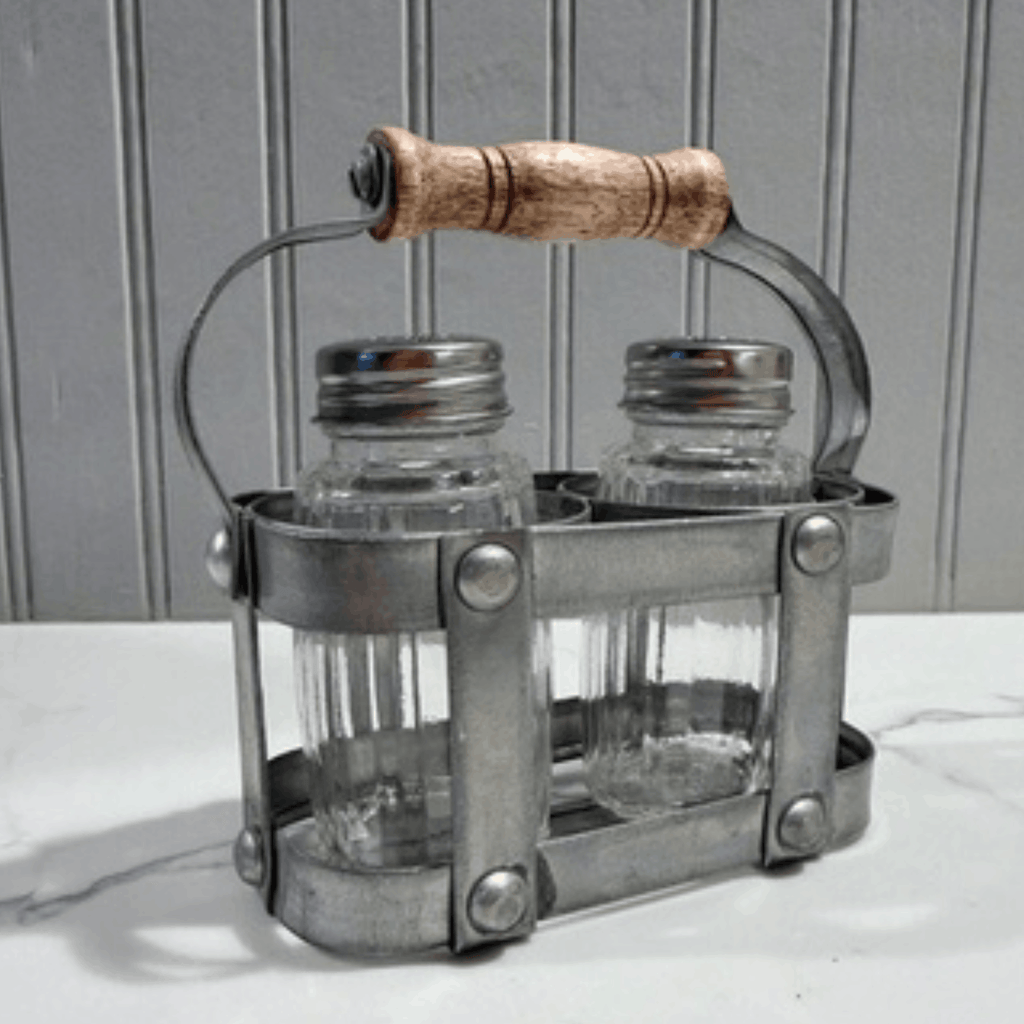 Metal salt and pepper shaker set with wooden handle on a neutral background